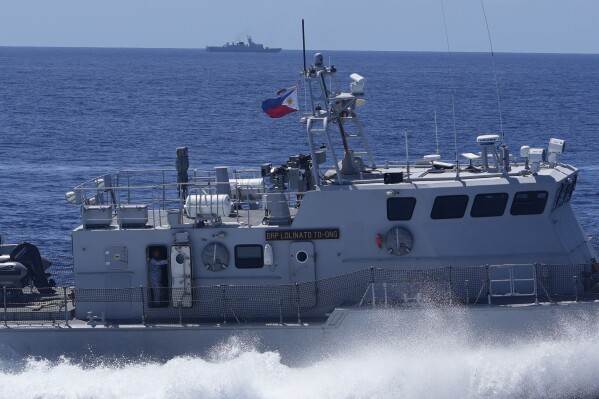 Philippine forces retake an island in mock combat as China’s navy watches