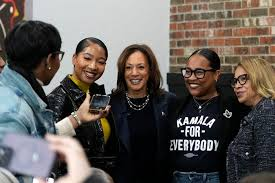 Harris stops by a chicken and waffles restaurant in Detroit and greets customers